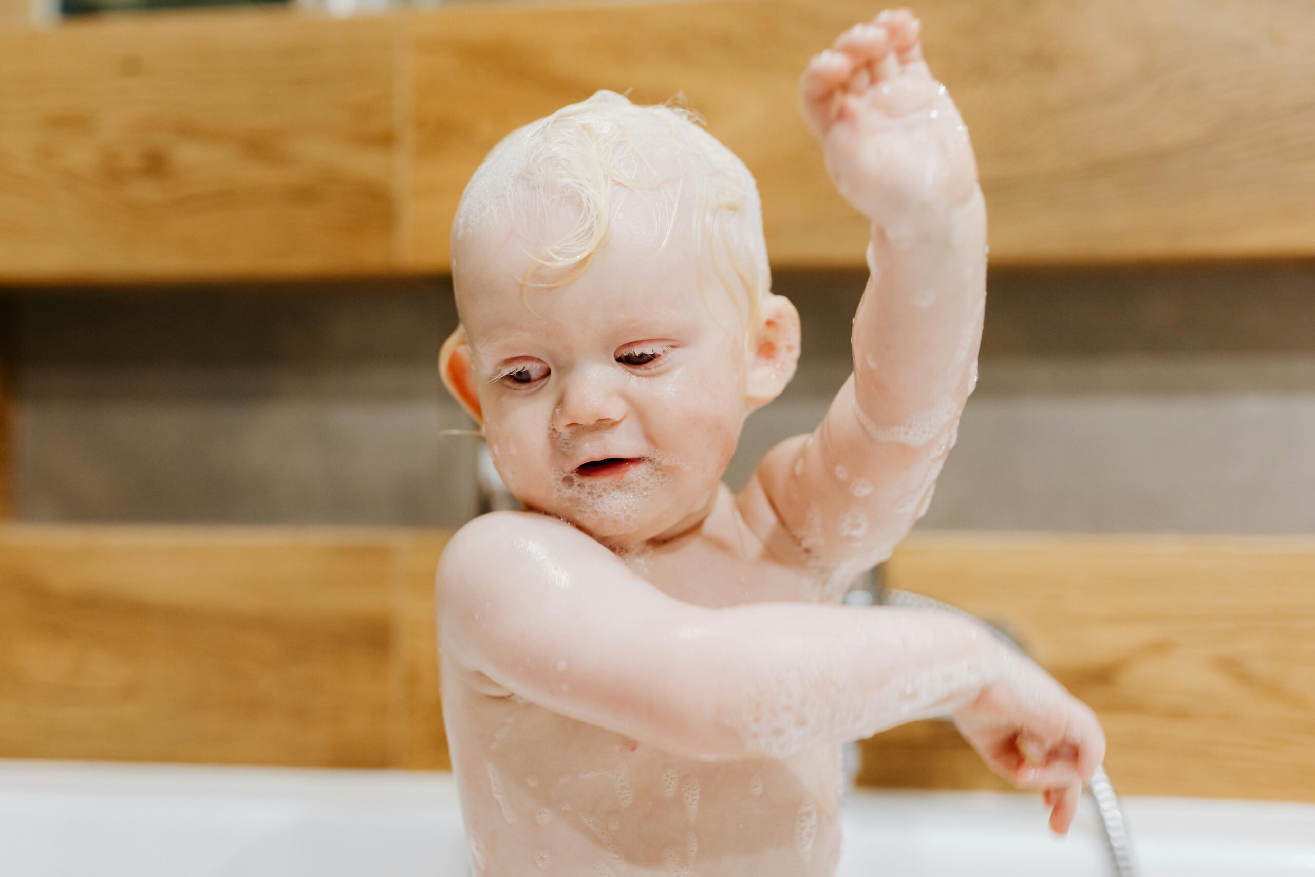 Baby taking a shower.